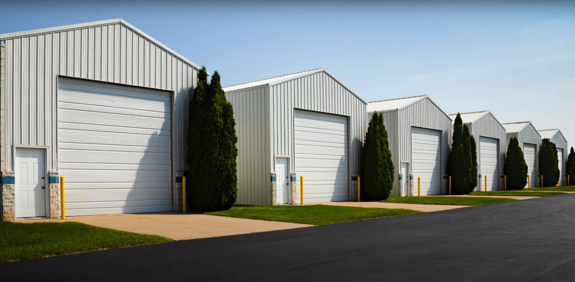 A technician performing professional commercial garage door repair on a large industrial overhead door.